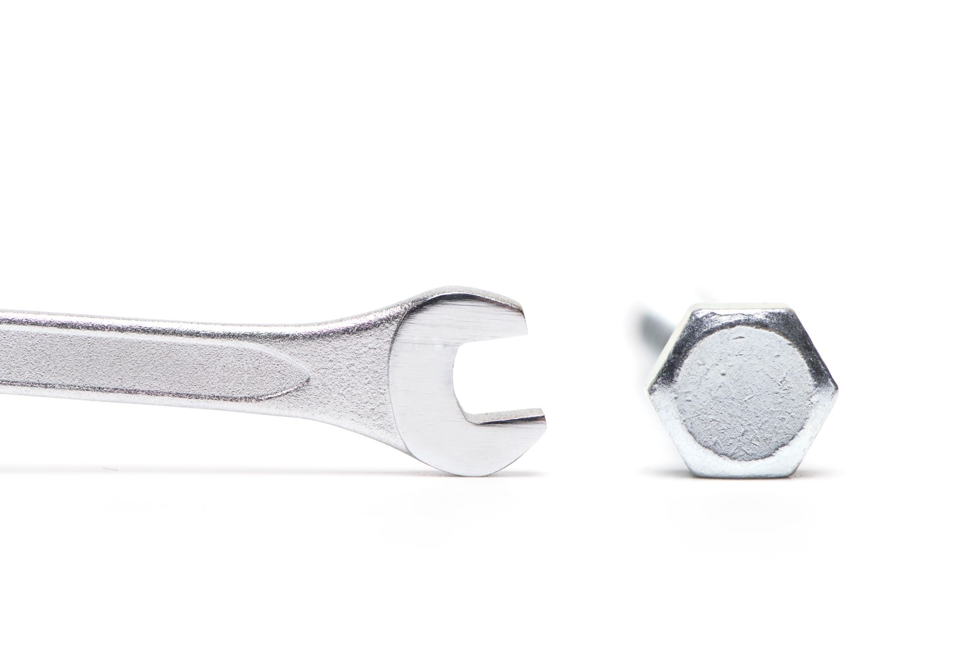 Small wrench trying to tighten an oversized bolt, symbolizing how misaligned B2B marketing tactics fail to deliver the business results you’re paying for.